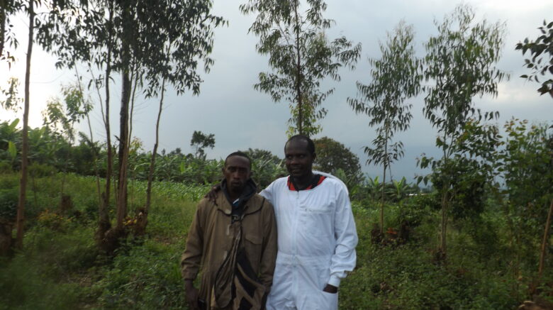 Claude in white with his beekeeping trainer